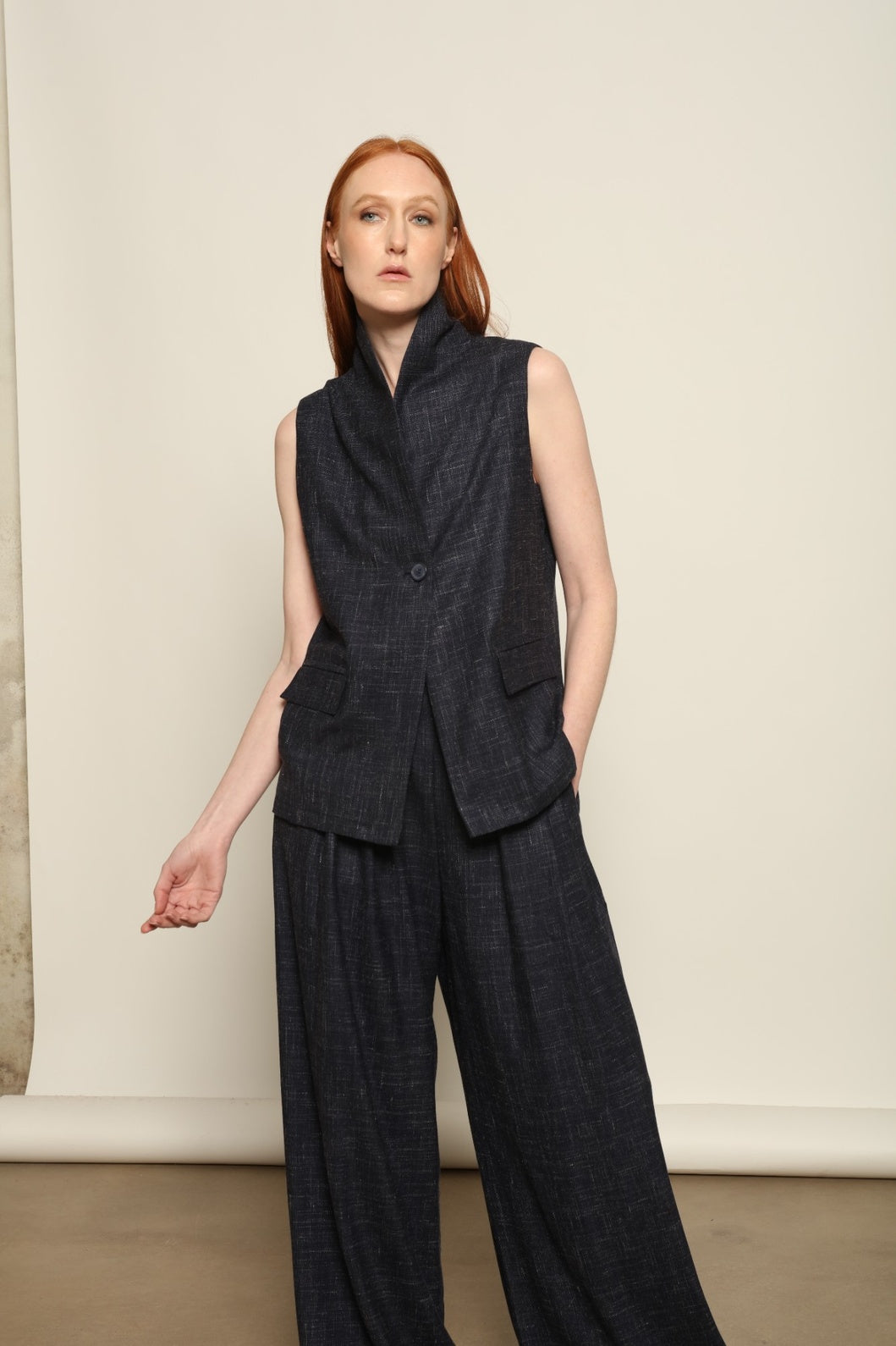 Model is wearing the Parigi night blue and white trousers from the House of Woven Stories selection, featuring fluid tailored pants made in Italy in Piedmont with an ethical fashion approach and timeless contemporary design.