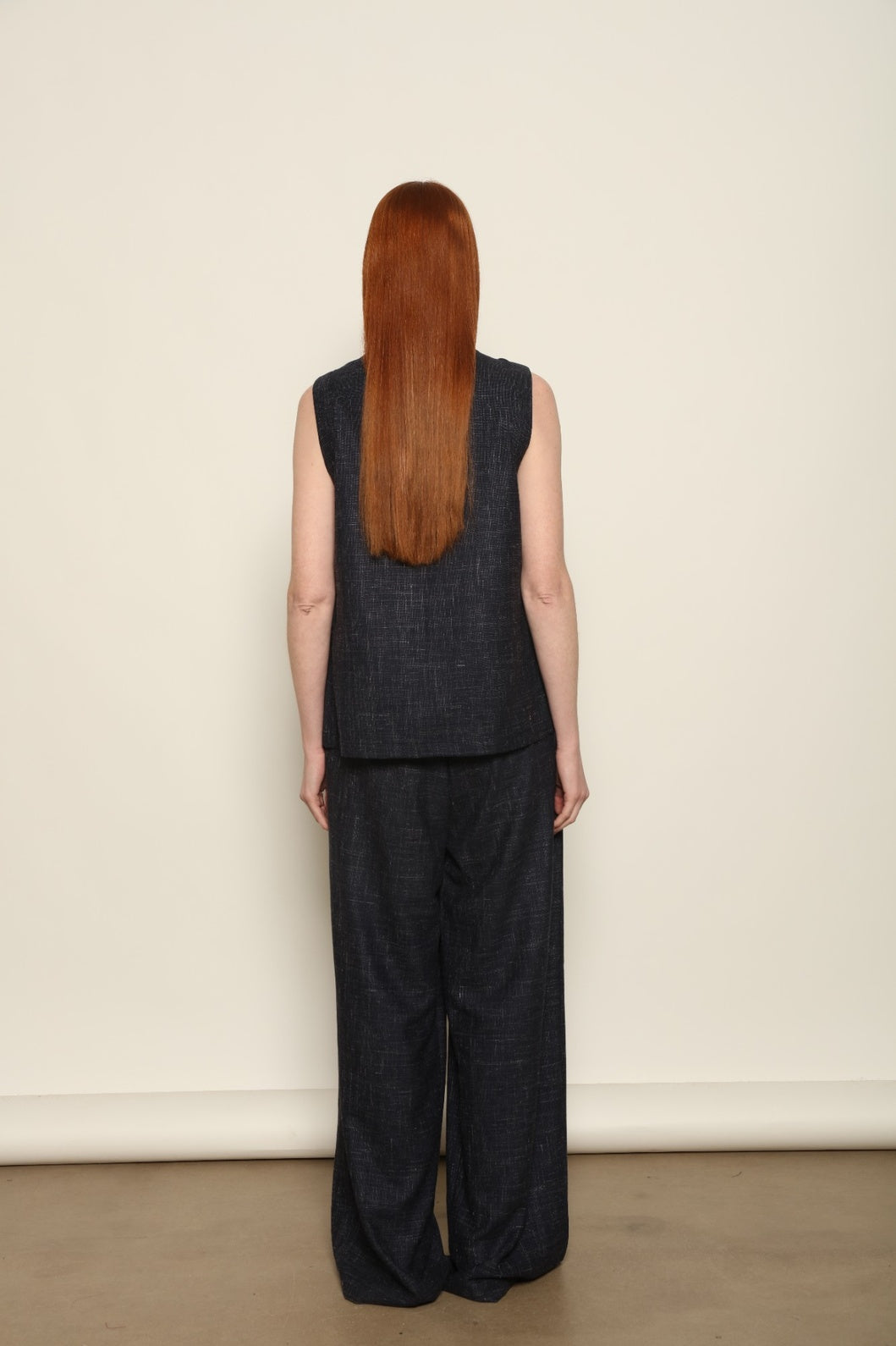 Model is wearing the Parigi night blue and white trousers from the House of Woven Stories selection, featuring fluid tailored pants made in Italy in Piedmont with an ethical fashion approach and timeless contemporary design.