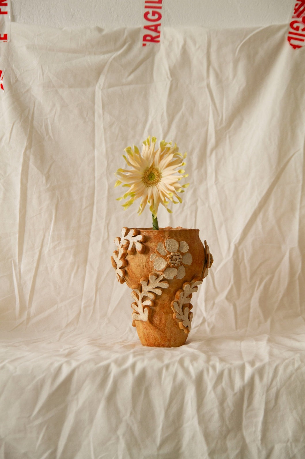 Petit Jardin n.05 by Clandestine Céramique, handmade in warm brown clay with a natural glossy glaze and hand-painted floral motifs, part of the House of Nomad Stories selection.