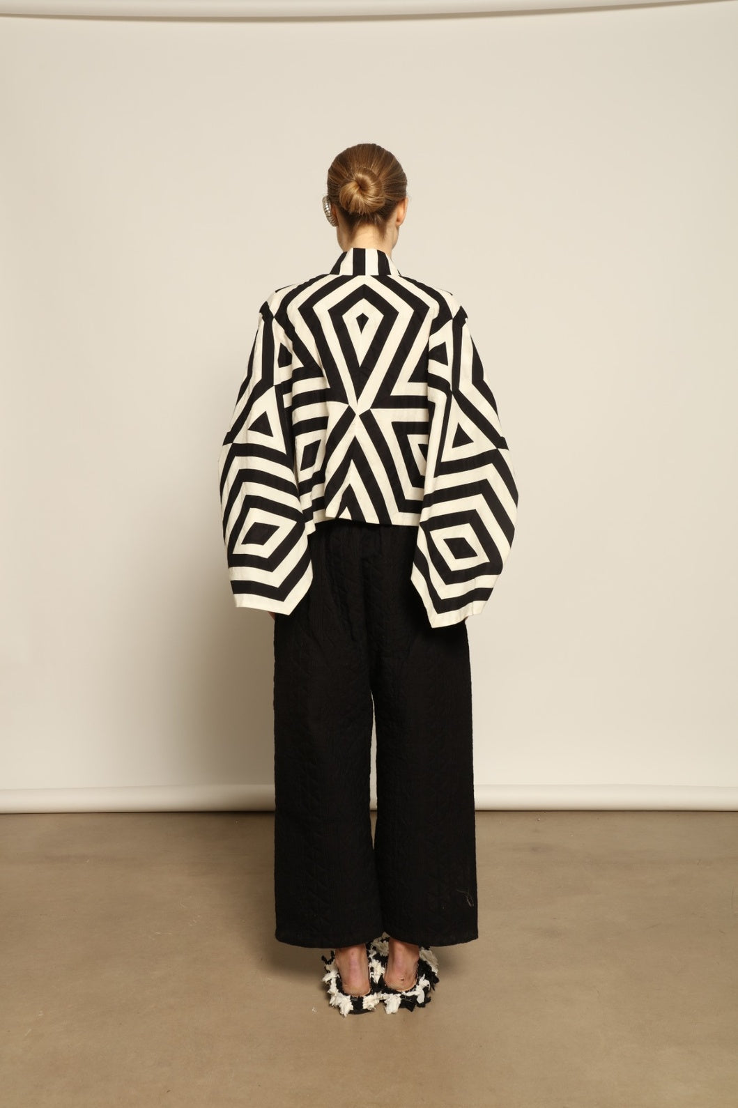 Model wearing Pure Cotton Tantra Black and White Jacket by Ka-Sha, part of the curated House of Woven Stories selection, handcrafted in India from premium cotton with hand-dyed appliqué detailing and a relaxed, artistic silhouette.