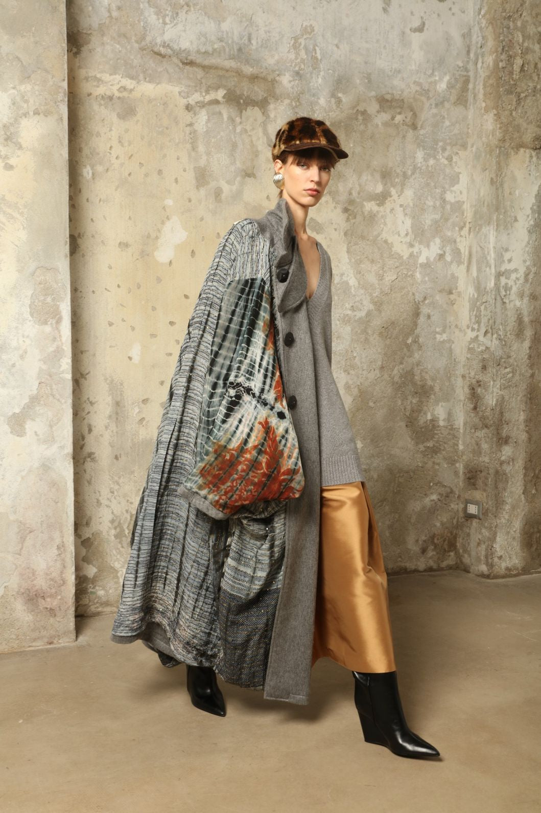 Model is wearing the Ryadh Long Coat in flannel grey by House of Woven Stories, made from merino wool and cashmere with silk lining and vintage 1960s buttons.