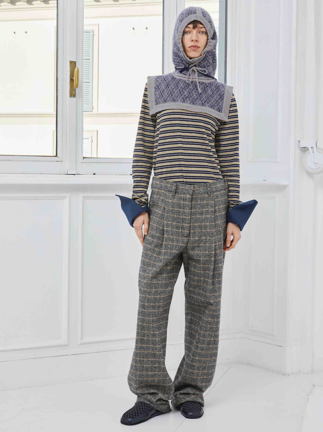Model is wearing the Sally Cotton Check Pant by Maison Jejia, part of the House of Nomad Stories selection, featuring a straight-leg fit, subtle check pattern, front pleats, belt loops, and side pockets.