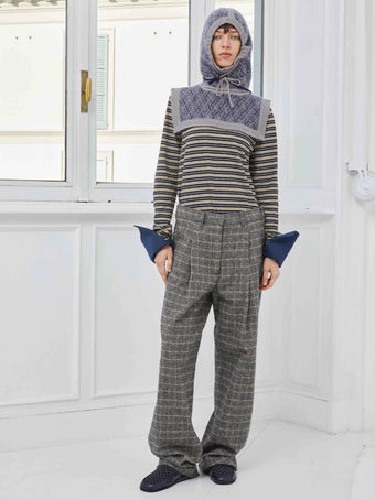 Model is wearing the Sally Cotton Check Pant by Maison Jejia, part of the House of Nomad Stories selection, featuring a straight-leg fit, subtle check pattern, front pleats, belt loops, and side pockets.