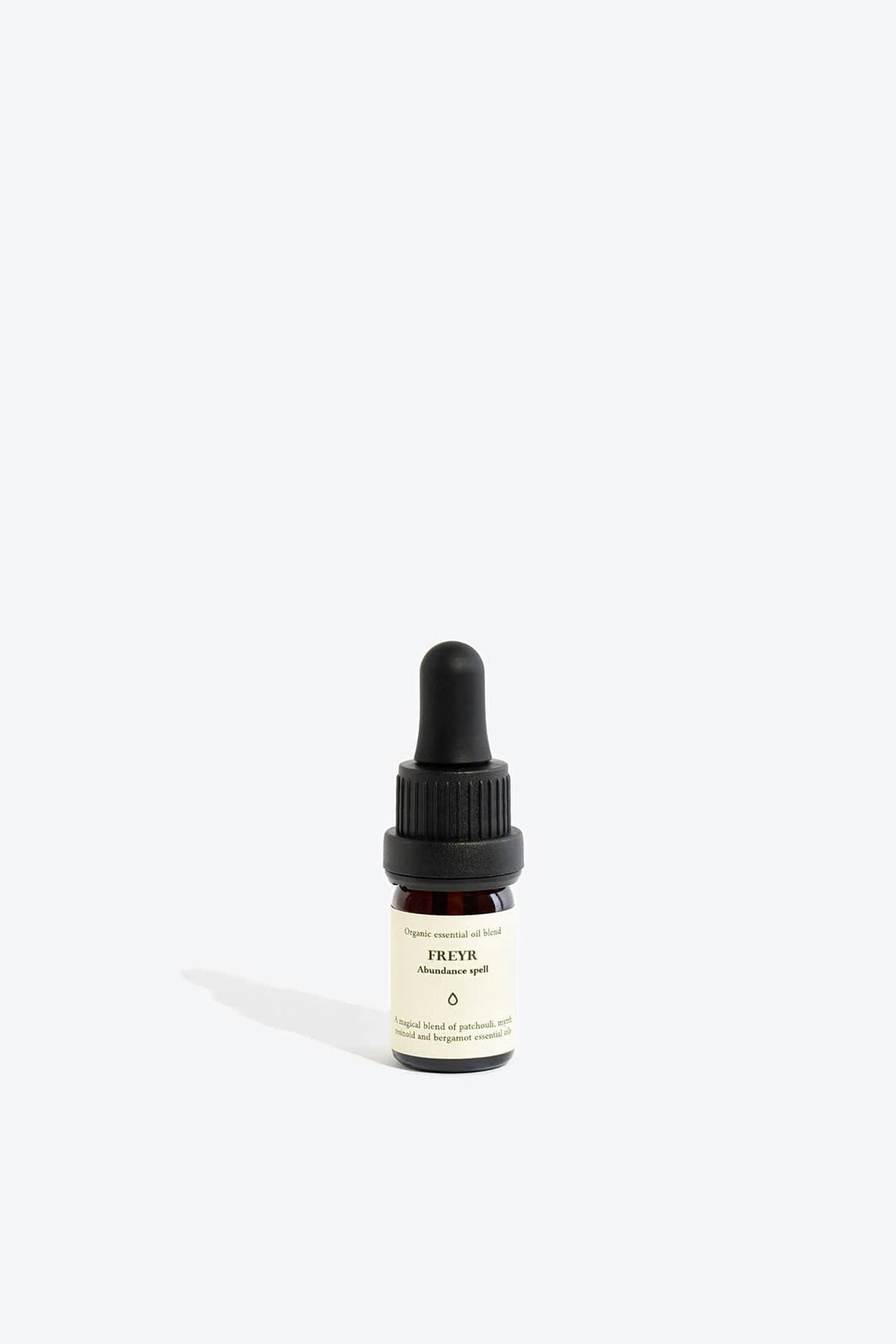 Organic essential oil blend Freyr by Smells Like Spells in elegant glass bottle with natural label, representing financial prosperity and Norse mythology, sold by House of Nomad Stories.