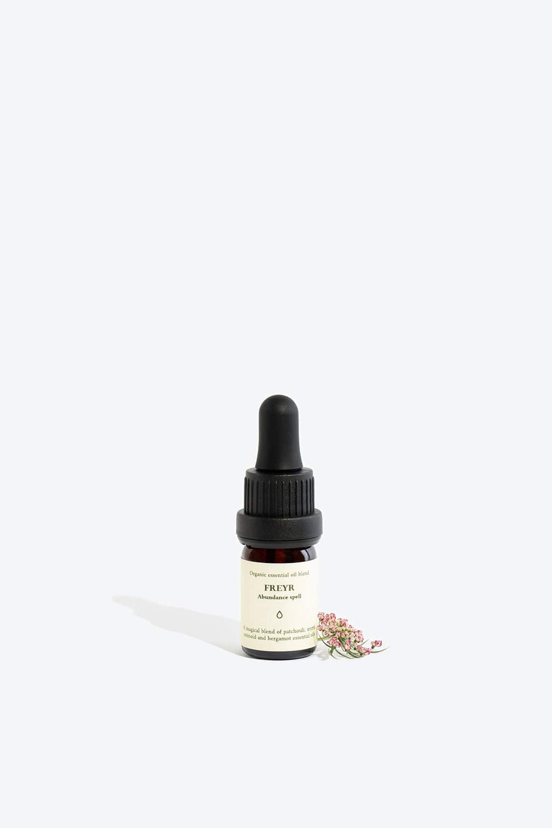 Organic essential oil blend Freyr by Smells Like Spells in elegant glass bottle with natural label, representing financial prosperity and Norse mythology, sold by House of Nomad Stories.