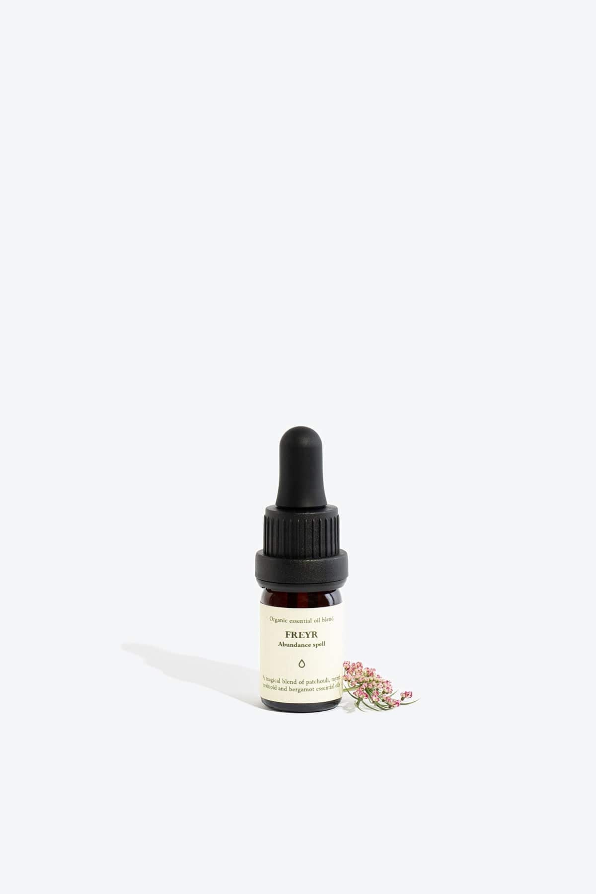 Organic essential oil blend Freyr by Smells Like Spells in elegant glass bottle with natural label, representing financial prosperity and Norse mythology, sold by House of Nomad Stories.