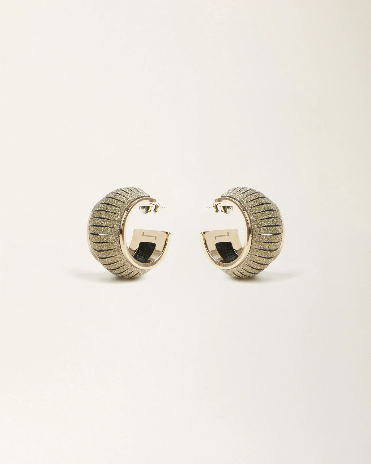 Cosmo Crystal Gold leather earrings by SO-LE STUDIO, handcrafted in Tuscany, softly rounded gold-toned design with crystal accents on the ears
