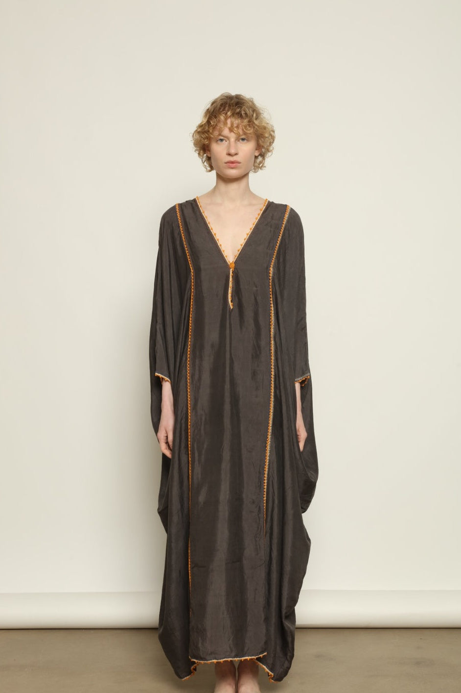 Model is wearing the Thea Grey Silk Dress by Supernaturae x HONS, crafted in handwoven silk from Murshidabad, featuring a relaxed flowing silhouette, elegant open back and natural hand-dyed grey tones. Part of the House of Woven Stories selection