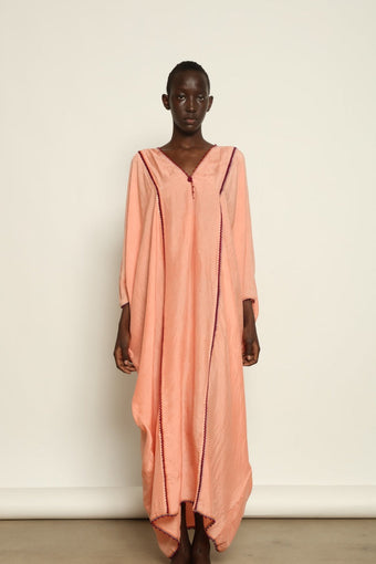 Model is wearing the Thea Rose Silk Dress by Supernaturae x HONS, crafted in handwoven silk from Murshidabad with a soft botanical rose dye finish, featuring a relaxed flowing silhouette and deep open back design. Part of the House of Woven Stories selection, this sustainable slow luxury piece reflects ethical artisan craftsmanship and natural dye variations.
