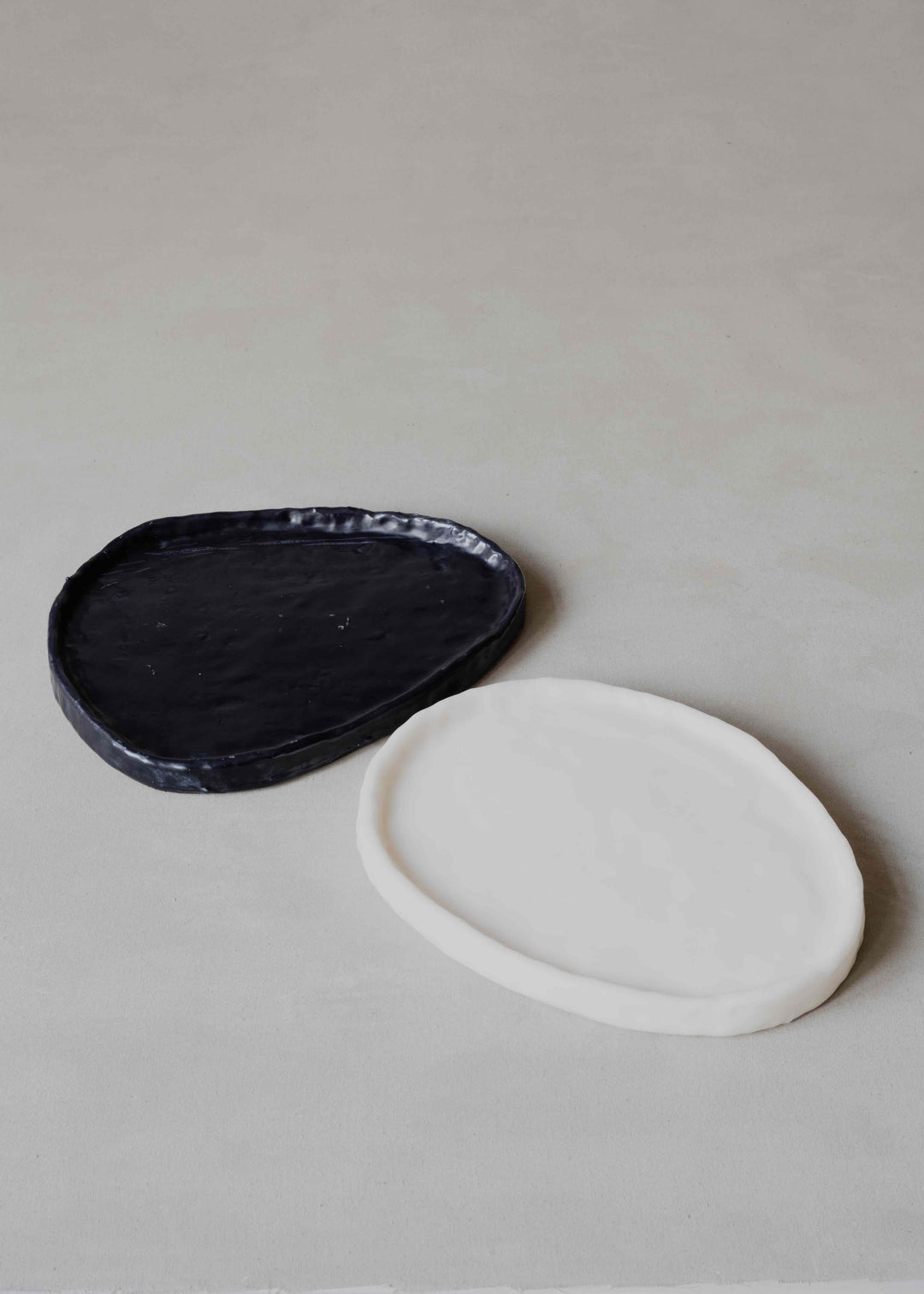 Tray Oval in Black by Oberflacht, part of the House of Nomad Stories selection, handcrafted from beeswax and paraffin with smooth matte finish and unique variations in colour and texture.