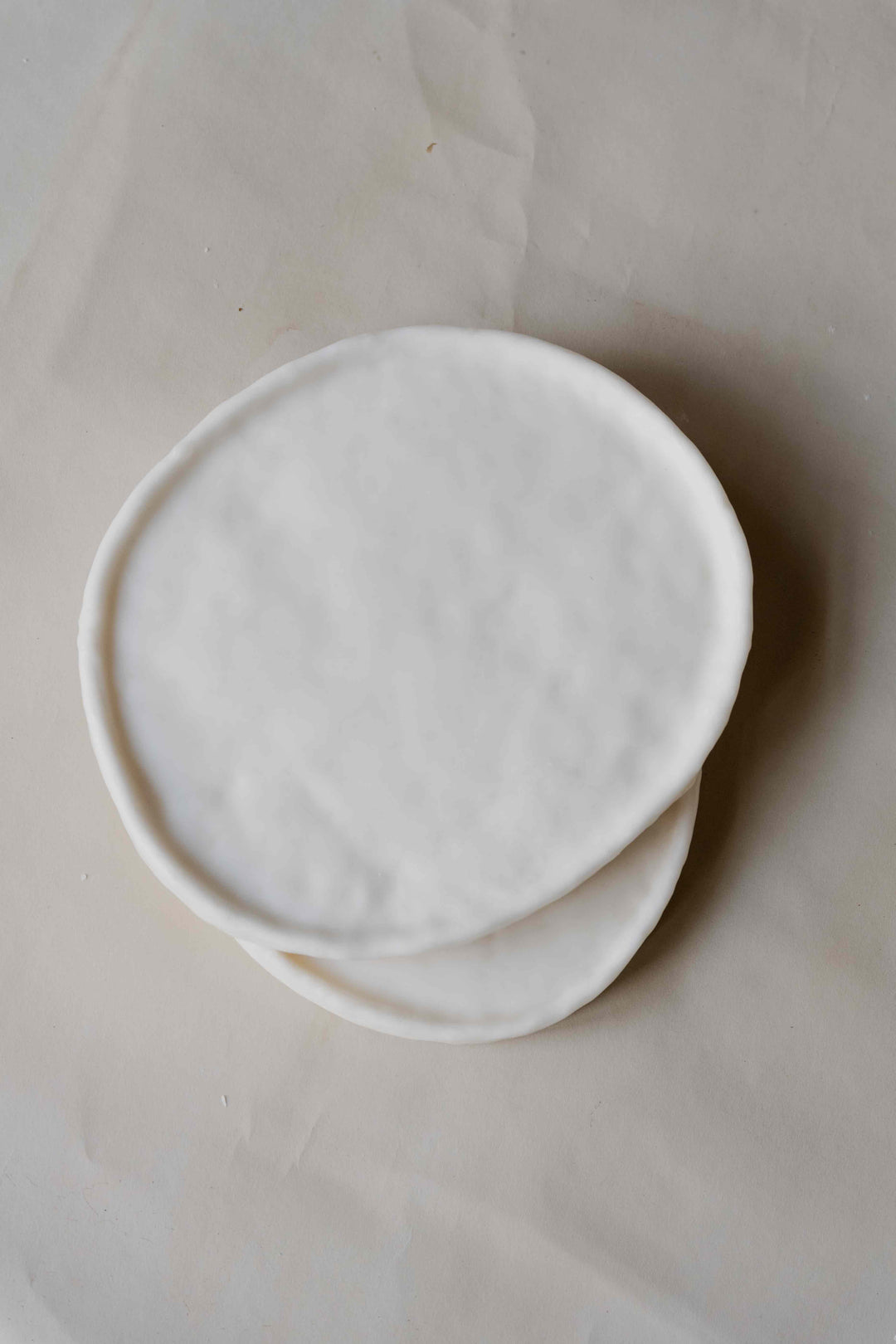 Tray Oval in Cream by Oberflacht, part of the House of Nomad Stories selection, handcrafted from beeswax and paraffin with smooth matte finish and unique natural variations.