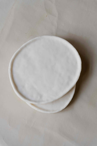 Tray Oval in Cream by Oberflacht, part of the House of Nomad Stories selection, handcrafted from beeswax and paraffin with smooth matte finish and unique natural variations.
