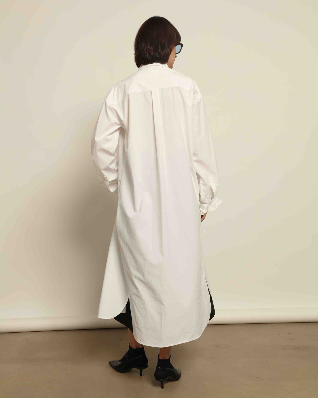 White Oscar Cotton Dress with asymmetric silk panel, crisp cotton fabric, sharp collar, and button-down front by House of Nomad Stories.
