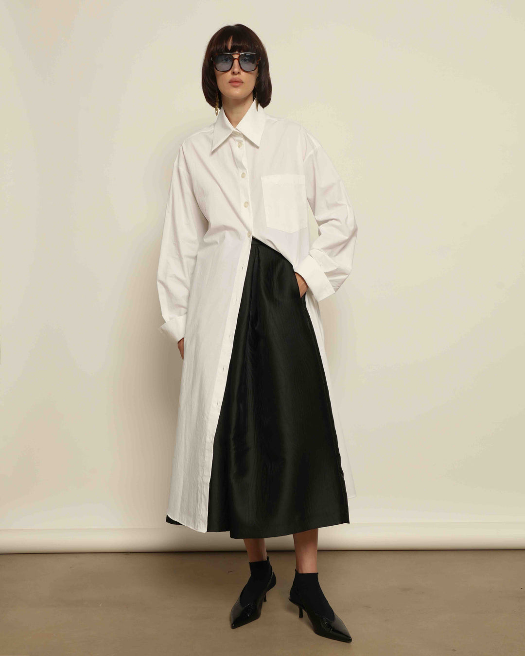 White Oscar Cotton Dress with asymmetric silk panel, crisp cotton fabric, sharp collar, and button-down front by House of Nomad Stories.