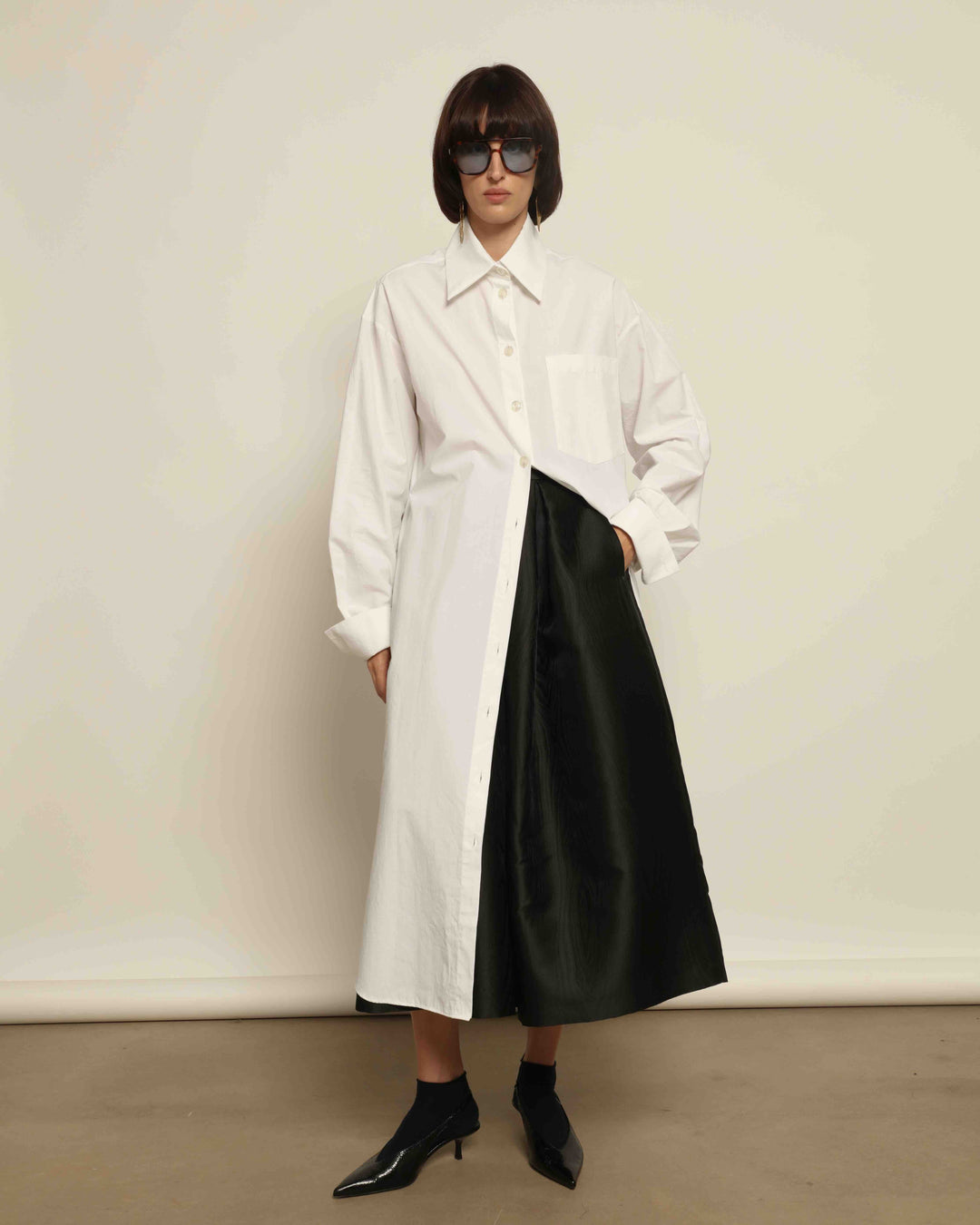 White Oscar Cotton Dress with asymmetric silk panel, crisp cotton fabric, sharp collar, and button-down front by House of Nomad Stories.