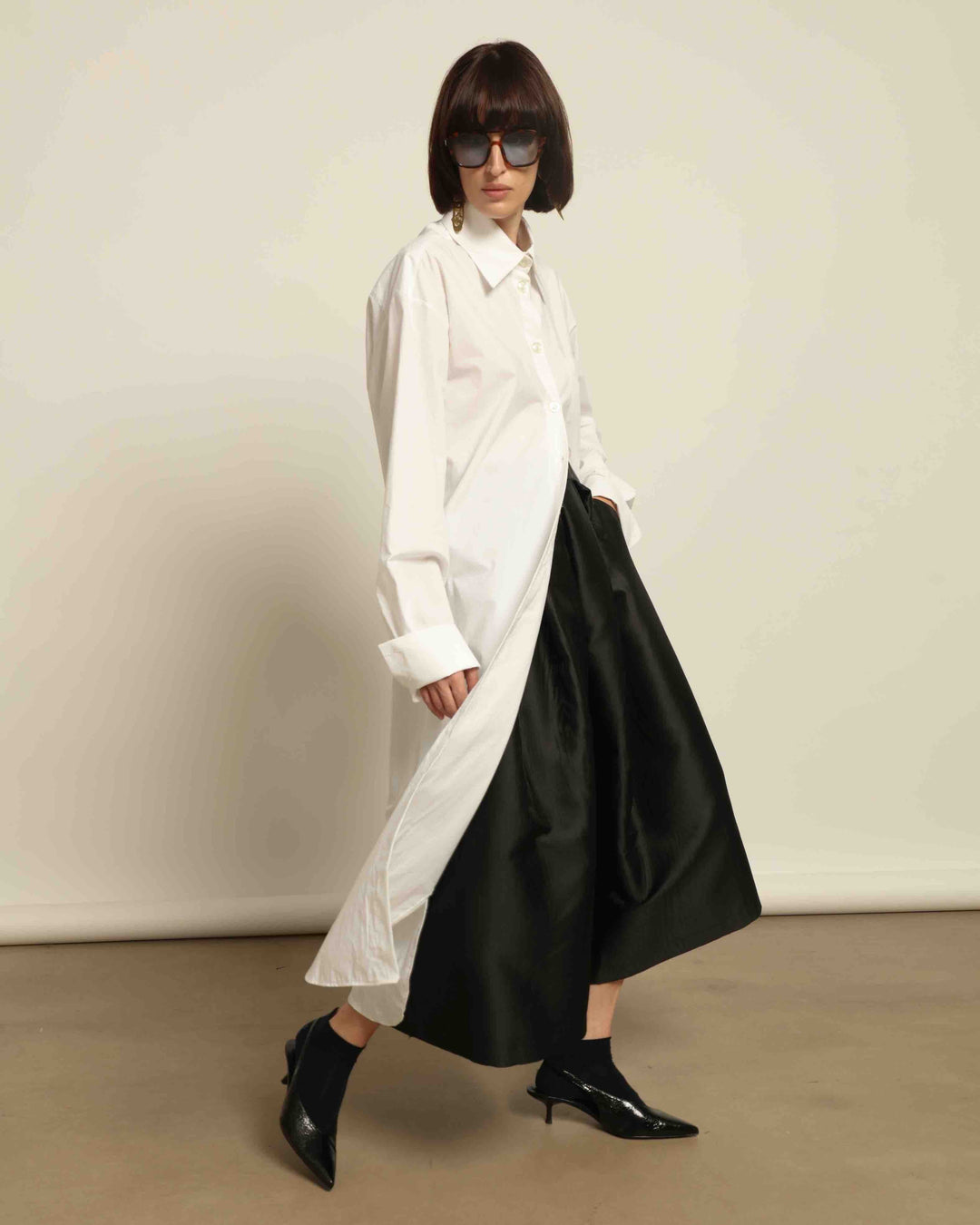 White Oscar Cotton Dress with asymmetric silk panel, crisp cotton fabric, sharp collar, and button-down front by House of Nomad Stories.