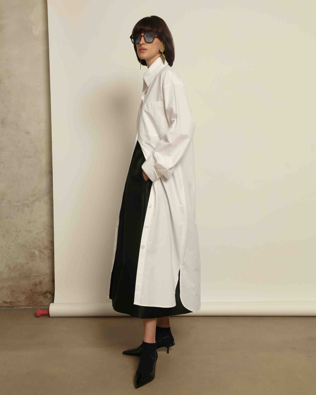 White Oscar Cotton Dress with asymmetric silk panel, crisp cotton fabric, sharp collar, and button-down front by House of Nomad Stories.
