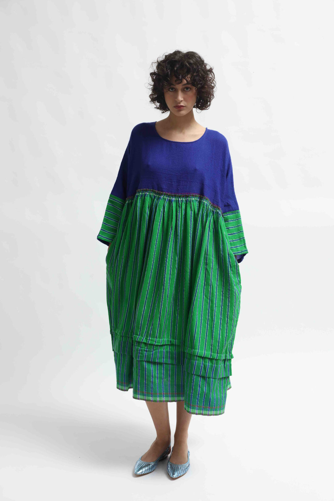 Model wearing the Injiri Wool Midi Dress, handcrafted in India in rich indigo and green tones with a contemporary striped detail, curated by House of Nomad Stories.