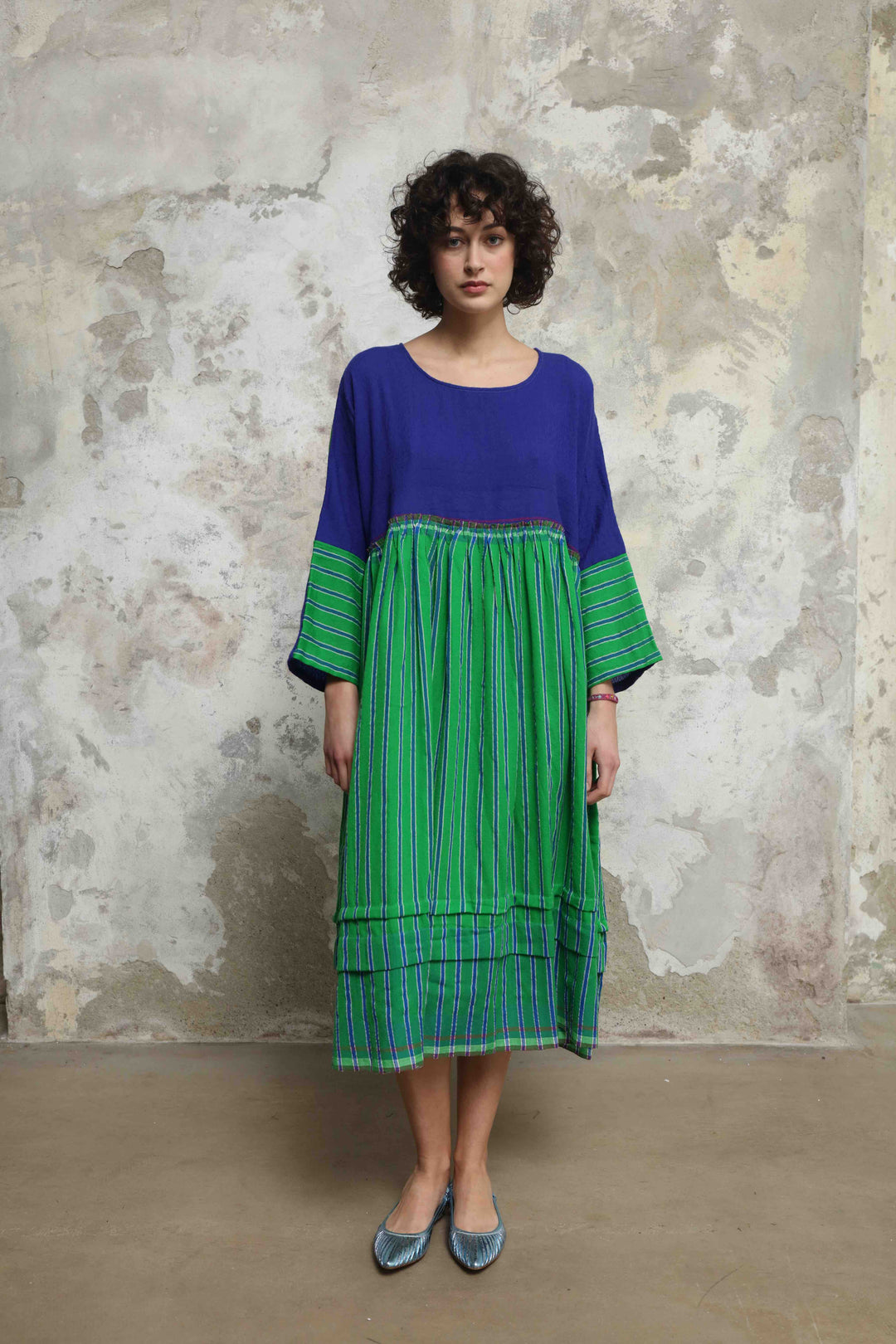 Model wearing the Injiri Wool Midi Dress, handcrafted in India in rich indigo and green tones with a contemporary striped detail, curated by House of Nomad Stories.