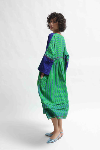 Model wearing the Injiri Wool Midi Dress, handcrafted in India in rich indigo and green tones with a contemporary striped detail, curated by House of Nomad Stories.